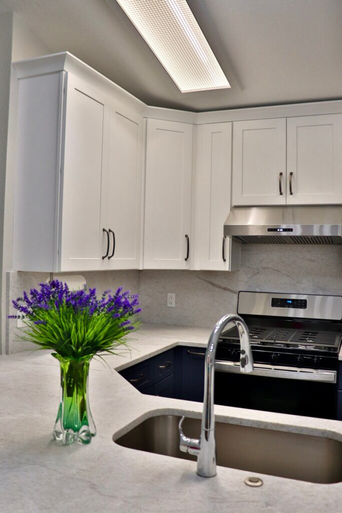 RTA Blue Shaker base cabinets, RTA White Shaker uppers in the kitchen