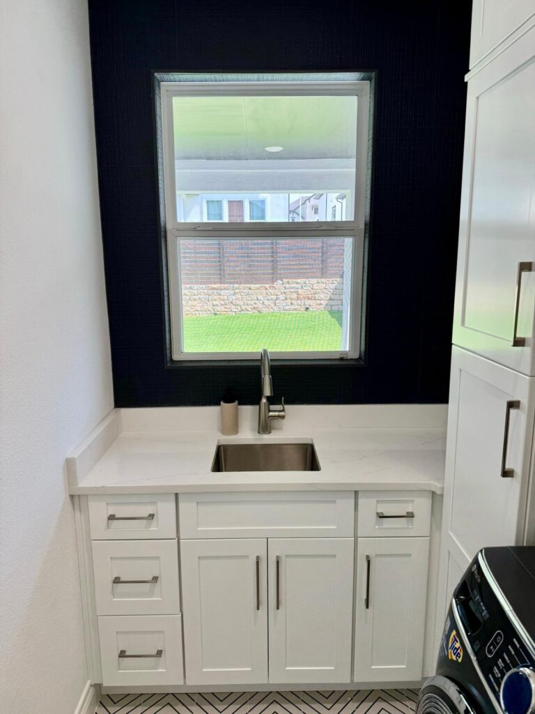 Fabuwood Graphite Galaxy on the main kitchen run, Durasupreme Black Paint on select pieces