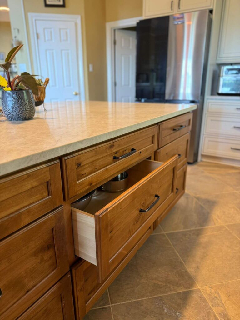 RTA Pearl Glazed Shaker on the perimeter, Durasupreme Knotty Alder on the island and coffee area, Taj Mahal quartzite countertops throughout