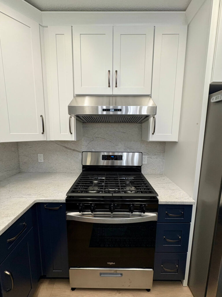 RTA Blue Shaker base cabinets, RTA White Shaker uppers in the kitchen