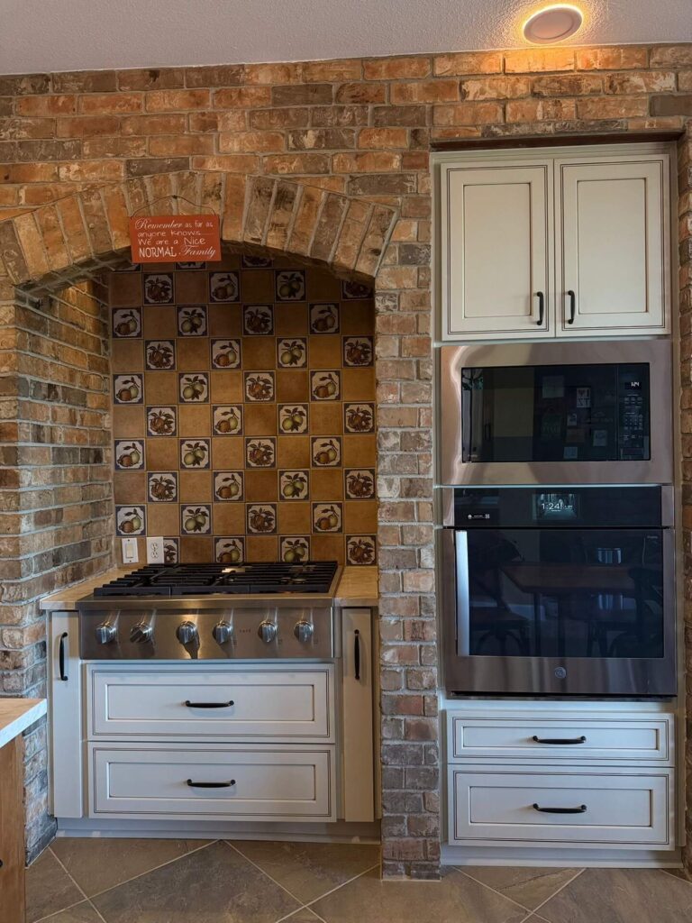 RTA Pearl Glazed Shaker on the perimeter, Durasupreme Knotty Alder on the island and coffee area, Taj Mahal quartzite countertops throughout