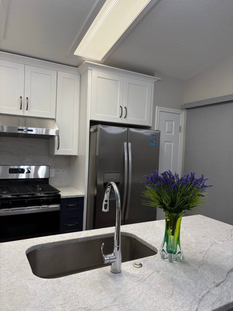 RTA Blue Shaker base cabinets, RTA White Shaker uppers in the kitchen
