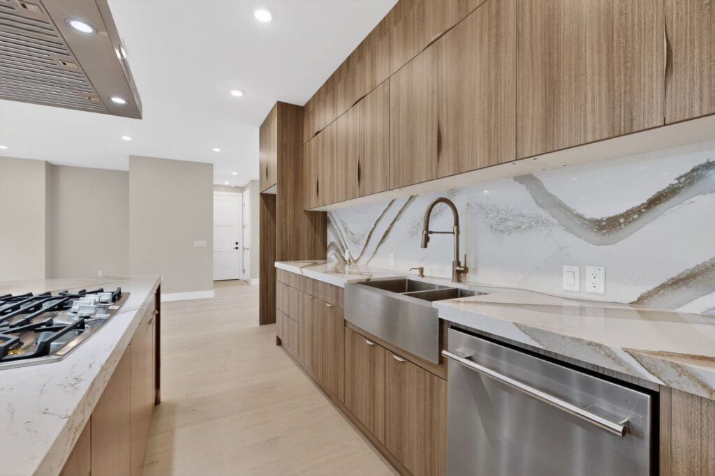 Walnut frameless kitchen cabinets with Cambria Britannica Gold Warm countertops in Austin Texas