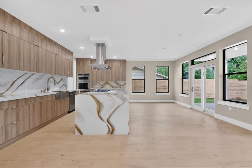 Walnut frameless kitchen cabinets with Cambria Britannica Gold Warm countertops in Austin Texas
